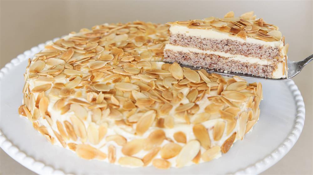 Swedish almond cake (Mandeltårta) is a cake that is made with two layers of almond meringue cake, in between there is a rich cream and all the cake is covered with toasted
